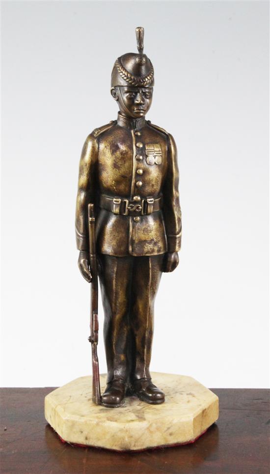 An early 20th century patinated military bronze model of a Kings Royal Rifle Corps soldier, 10.5in.